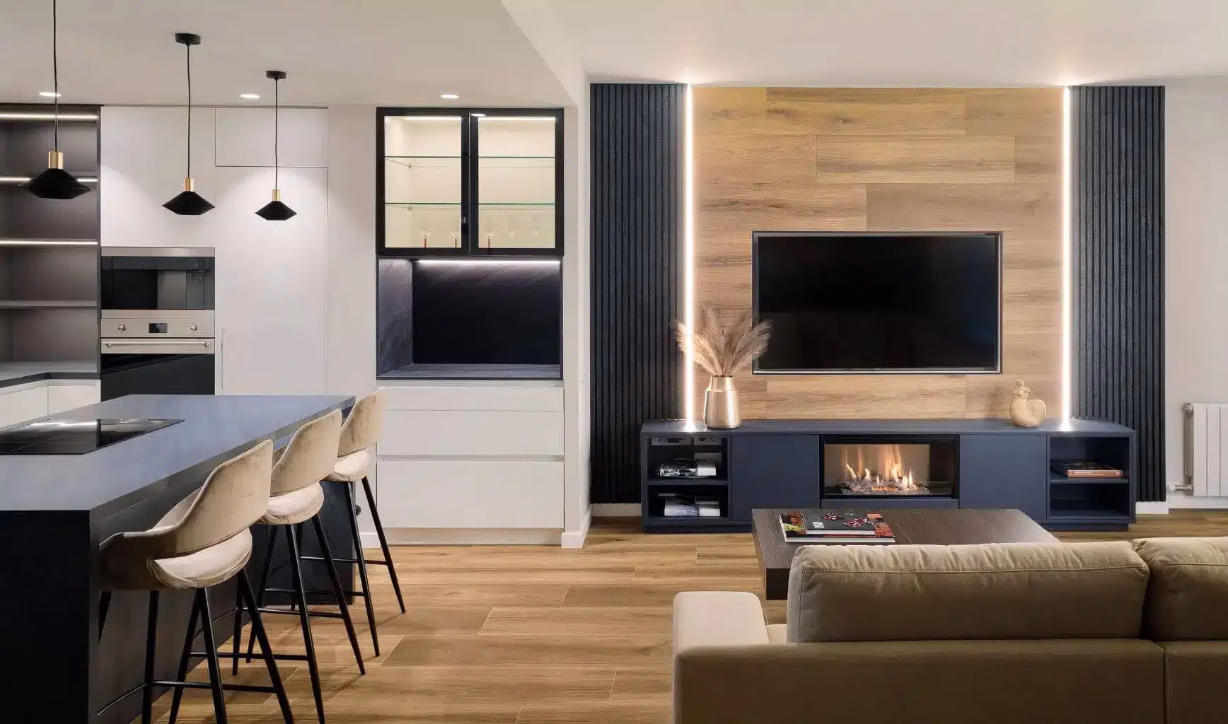 Cocina abierta al salón con televisión y chimenea